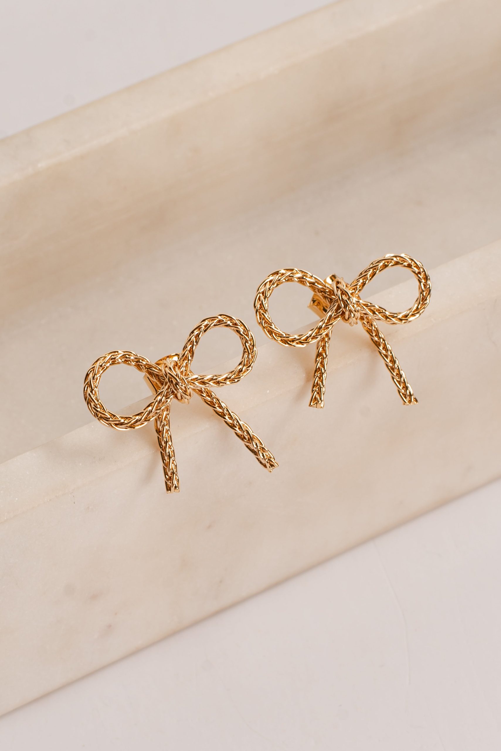 shopdressup_gold_bow_earrings-3_68176c9c-107f-44bf-8f8f-31e219c44872.jpg